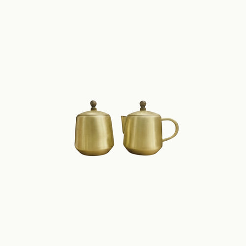 Brass  on a white backgroundilk and sugar pot on white background