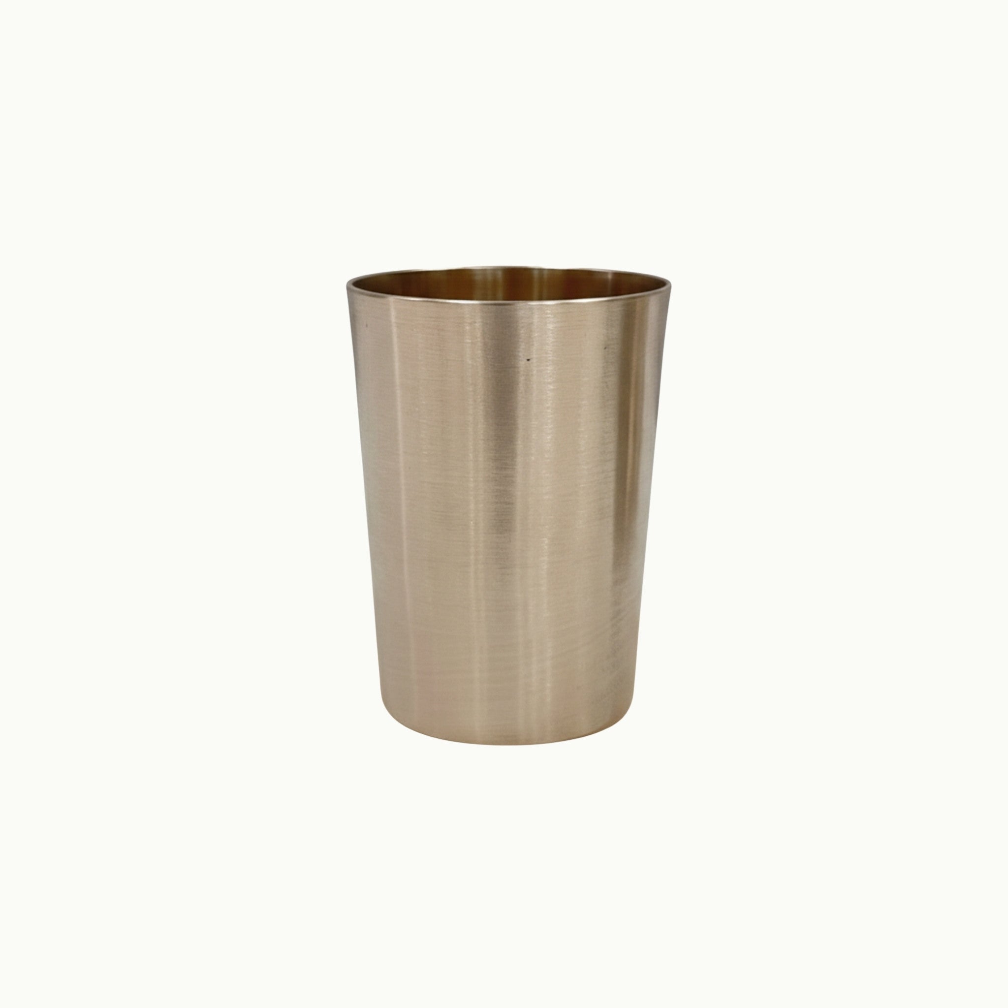 A bronze metal cup or tumbler with a warm metallic finish, shown against a plain off-white background.